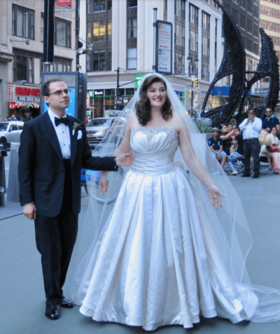 Couple in wedding attire in foreground, New York in Background