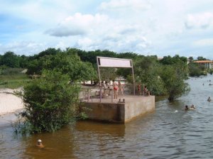 A picture of swimmers on a concrete platform in the Amazon taken from boutique riverboats.