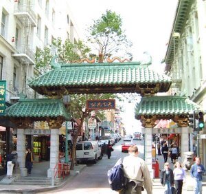 san francisco chinatown gate with man with backpack in front